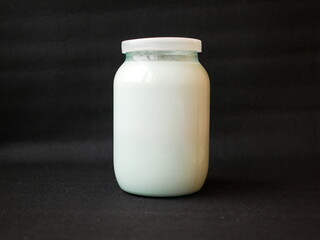 Jar with milk on a black background