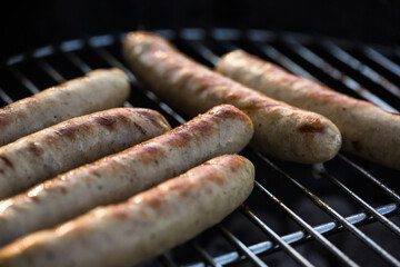 Close up of grilled sausages on barbecue grill.