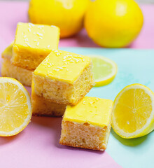 Lemon cake slices with sprinkles on a colourful background.