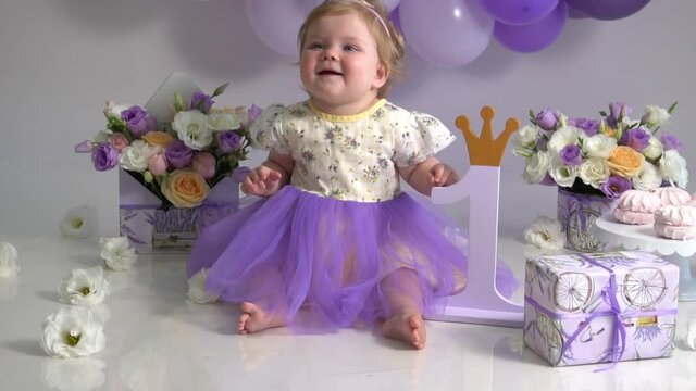 Slow Motion adorable baby girl with spring flowers