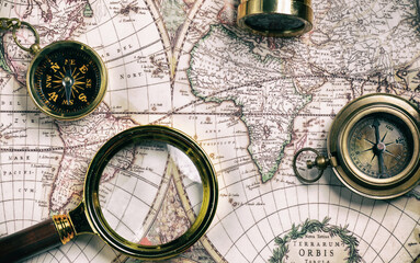 Vintage style navigational objects on an old world map