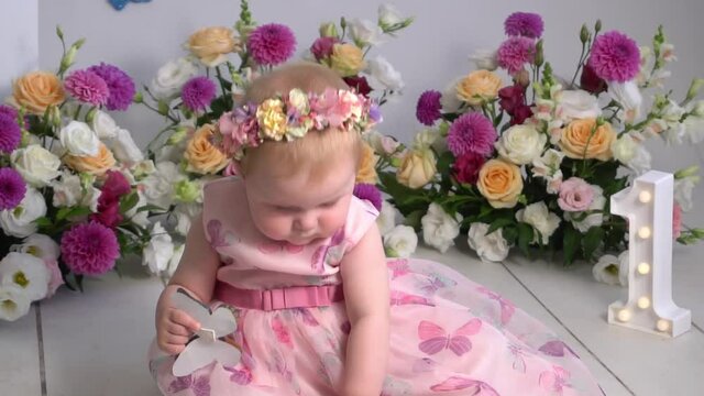 Cute little girl in a pink princess dress with a flower