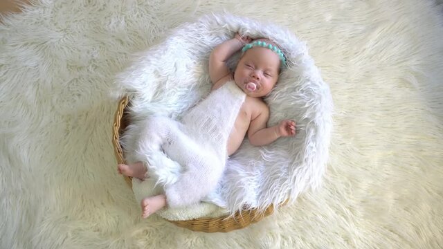 4K sleeping newborn baby in a basket