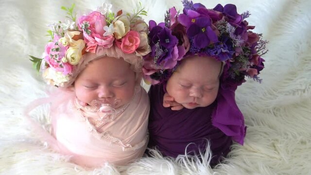 Slow Motion Girls twins in wreaths from flowers 
