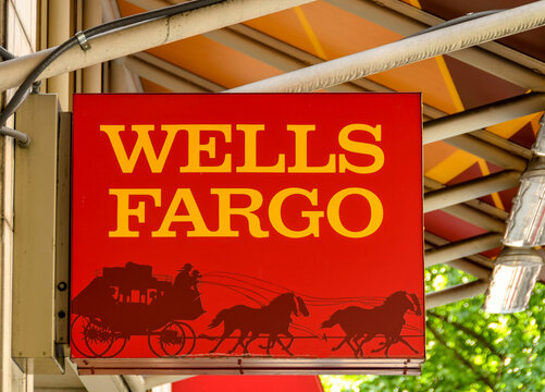 Seattle, Washington State, USA - June 2018: Close up view of the sign outside the entrance to a branch of the Wells Fargo bank in Seattle city centre.