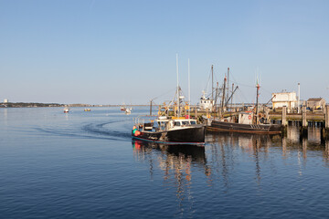 Fototapeta premium view to ships from Pier in Provincetown in sunset