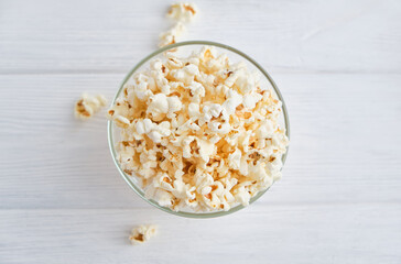 bowl with homemade popcorn on wooden background.