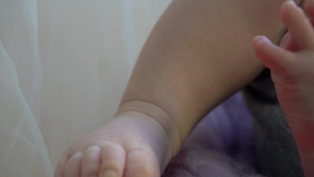 Slow Motion Beautiful little heels of a newborn baby 
