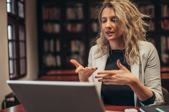 Businesswoman using a laptop for on online meeting in her office