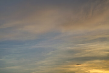 The sky at sunset. Cumulus clouds lit by the rays of the setting sun.