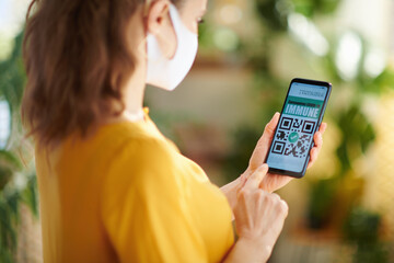 Seen from behind woman in house in sunny day