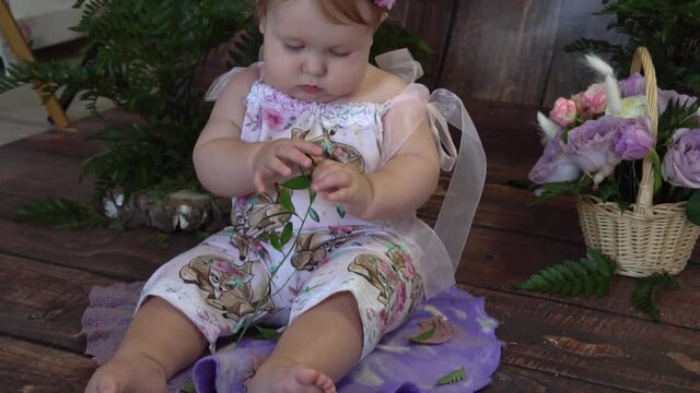 Slow Motion Image of sweet baby girl in a wreath of flowers