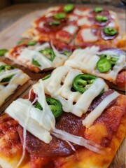 Pizza with pepperoni and jalapeño