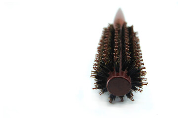 Round wooden hair brush on the white background.  Сopy space for your text. Closeup