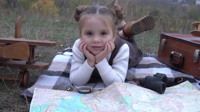 Slow Motion Little girl in a uniform with a world map and pointer. 