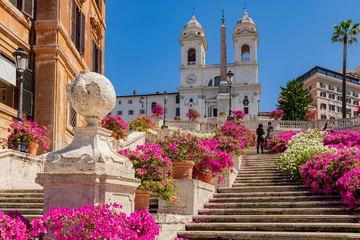 Fotobehang Perspective panorama of the famous Spanish Steps with the Trinita dei Monti church the obelisk in the center of Rome, with a blue sky, clouds and azaleas flower display.Rome, Italy. © Paolo Savegnago