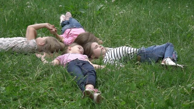 Slow Motion Image of funny kids playing on the grass
