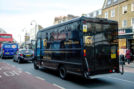 London, United Kingdom - March 9, 2017: Rear view of Electric Vehicle UPS United Parcel Services postal delivery van driving on London street - traffic jam in city center