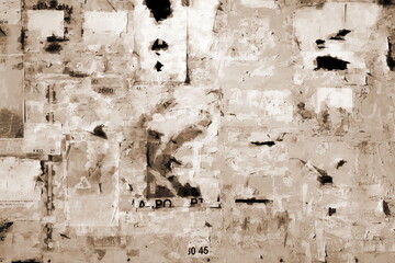 Old Billboard with Torn Posters. Dirty Street Wall with Crumpled, Wrinkled, Creased, Worn and Torn Posters. Abstract Vintage Background and Texture.