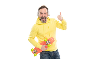 mature happy man with headphones and penny board. senior guy listen music isolated on white.