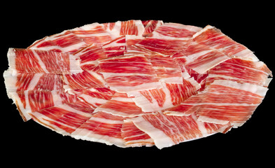 Plato de jamón  de cerdo ibérico de pata negra de bellota. Carne de cerdo curada roja con vetas de tocino blanco.