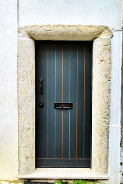 Old and colorful striped wooden door with iron details