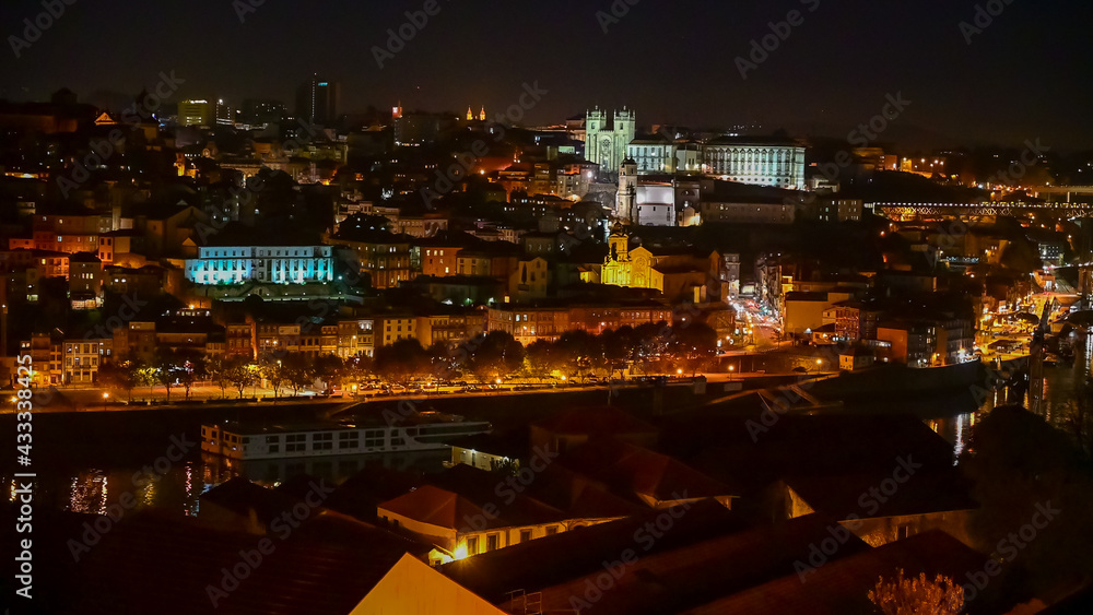 Wall mural panoramic view on douro river and old part of porto city in portugal at night