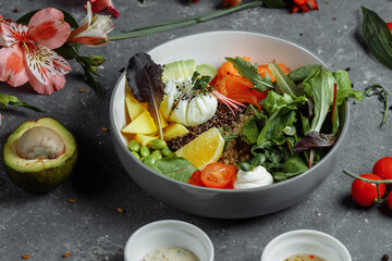 fresh healthy light breakfast, business lunch. Breakfast with poached egg, buckwheat, red fish, fresh salad, cucumbers, business lunch concept