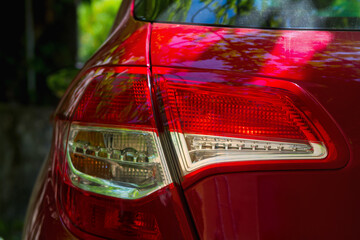 Back headlight with parking lights on a red car, close up - 433340833
