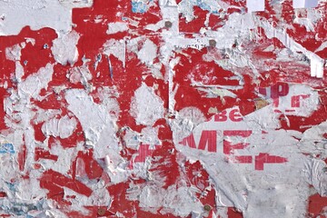 Urban Dark Wall with Ripped Posters and Ads. Grunge Abstract Isolated Background. Vintage Street Graffiti Wall Background and Texture for Text or Image. Creative Urban Wallpaper For Design.