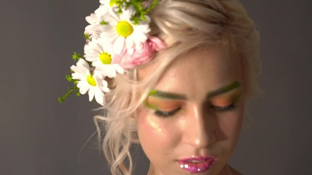 Slow Motion Beautiful girl with flowers in her hair. Spring.