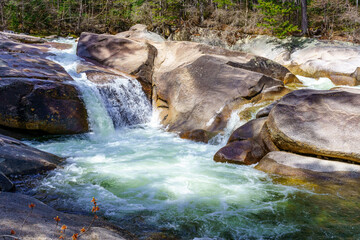 Waterfall on the Pemigevasset river in the spring among the forest. Lincoln Woods Trail. White...