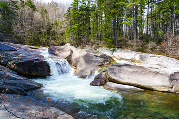 Spectacular view on flowing water of the Franconia waterfall by the lincoln woods trail on the pemigewasset river in spring. White Mountains National Forest, NH