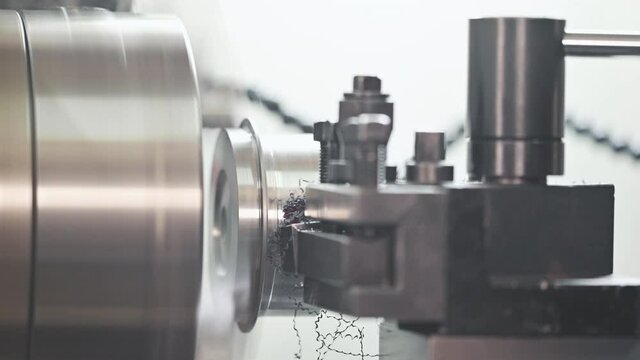 Close up view of high precision turning operation on a multi axis lathe, CNC machine tool. High quality 4k footage