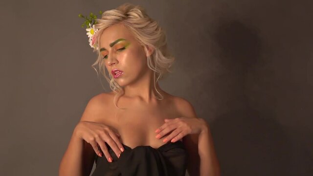 Slow Motion Beautiful tall blonde standing nude in fabric