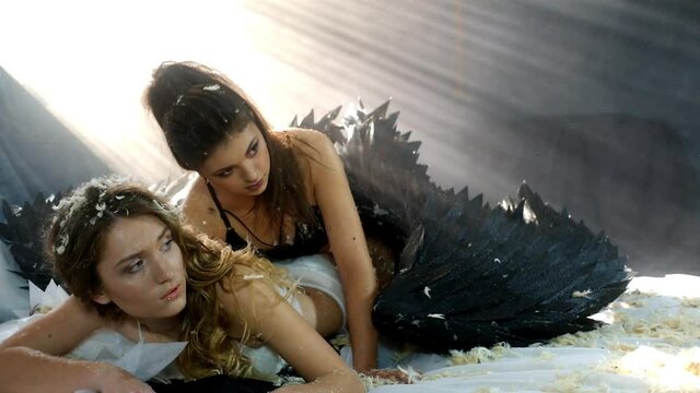 Beautiful young models wearing angel wings in the studio