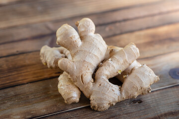 fresh ginger root on rustic wooden board blackground