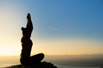 woman doing yoga on the mountain