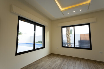 Room interior after renovation, unfurnished apartment with white walls and color pattern on the wall