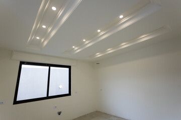 Room interior after renovation, unfurnished apartment with white walls and color pattern on the wall