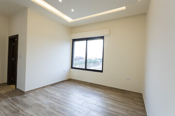 Room interior after renovation, unfurnished apartment with white walls and color pattern on the wall