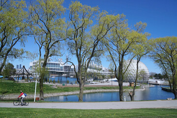 Waterfront park in Toronto called Ontario place, with walking and cycling paths and exhibition buildings beside a lagoon
