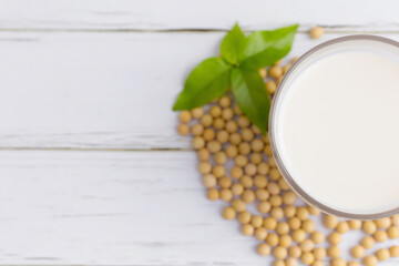 Soy milk and Soybeans on wooden table background. Healthy food Concept.