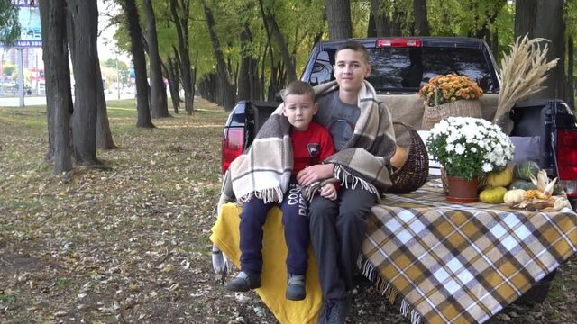 Slow Motion Kids sitting in pile of pumpkins outdoor