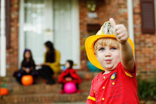 Boy wearing fireman's helmet