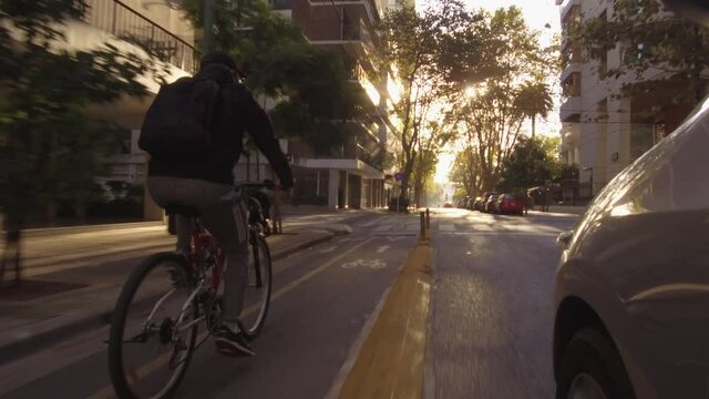 Cyclist commuting in the city. Bike lane / path. POV point of peddling on road, street, city, traffic - messenger
