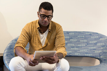 Young man using digital tablet