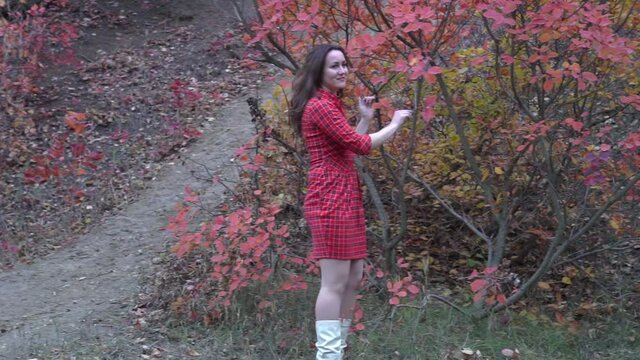 Slow Motion Woman standing in yellow autumn park. 