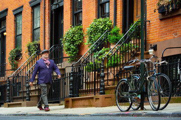 bohemian artist man in colorful clothes walking in the west village in New York - obrazy, fototapety, plakaty