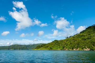Fototapeta na wymiar Green mountains, emerald green sea, blue sky make Iriomote Island a perfect place for boat trips and diving.